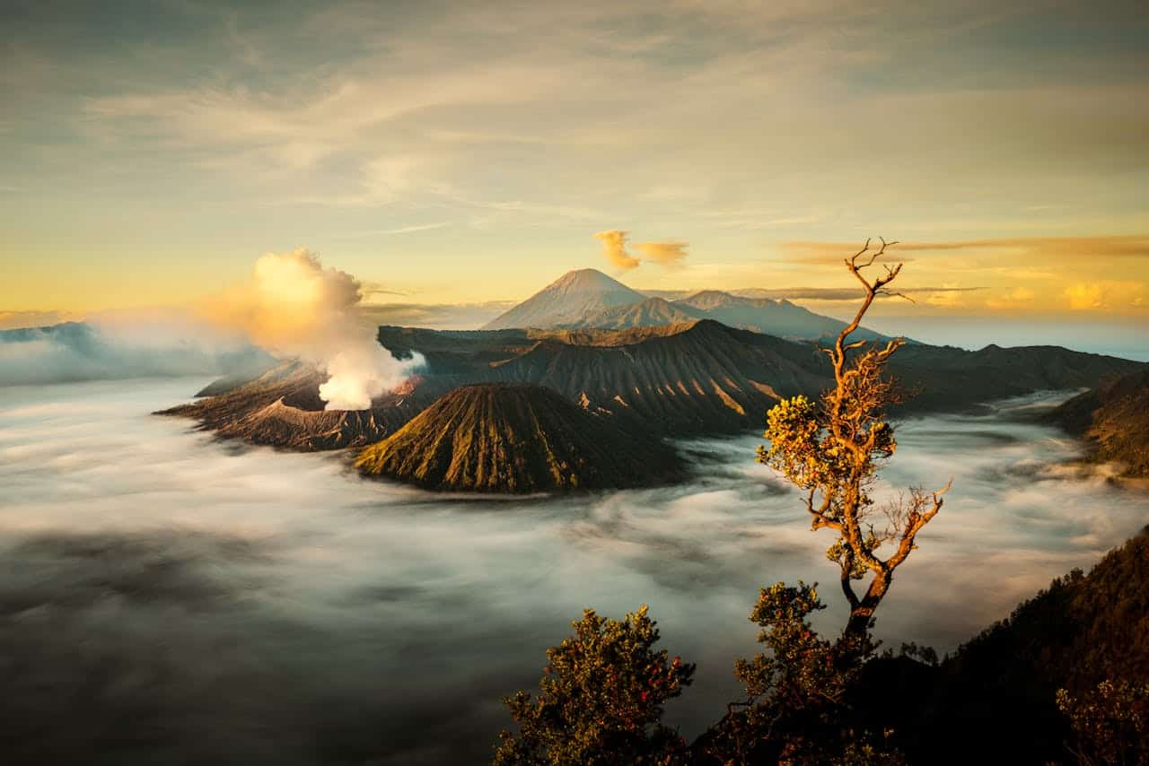 Breathtaking view of Mount Bromo shrouded in mist during sunrise in Jawa Tengah, Indonesia.